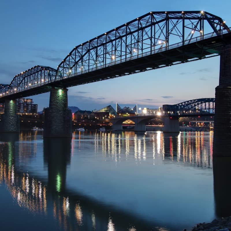 Chattanooga riverfront skyline and pedestrian bridge at dusk